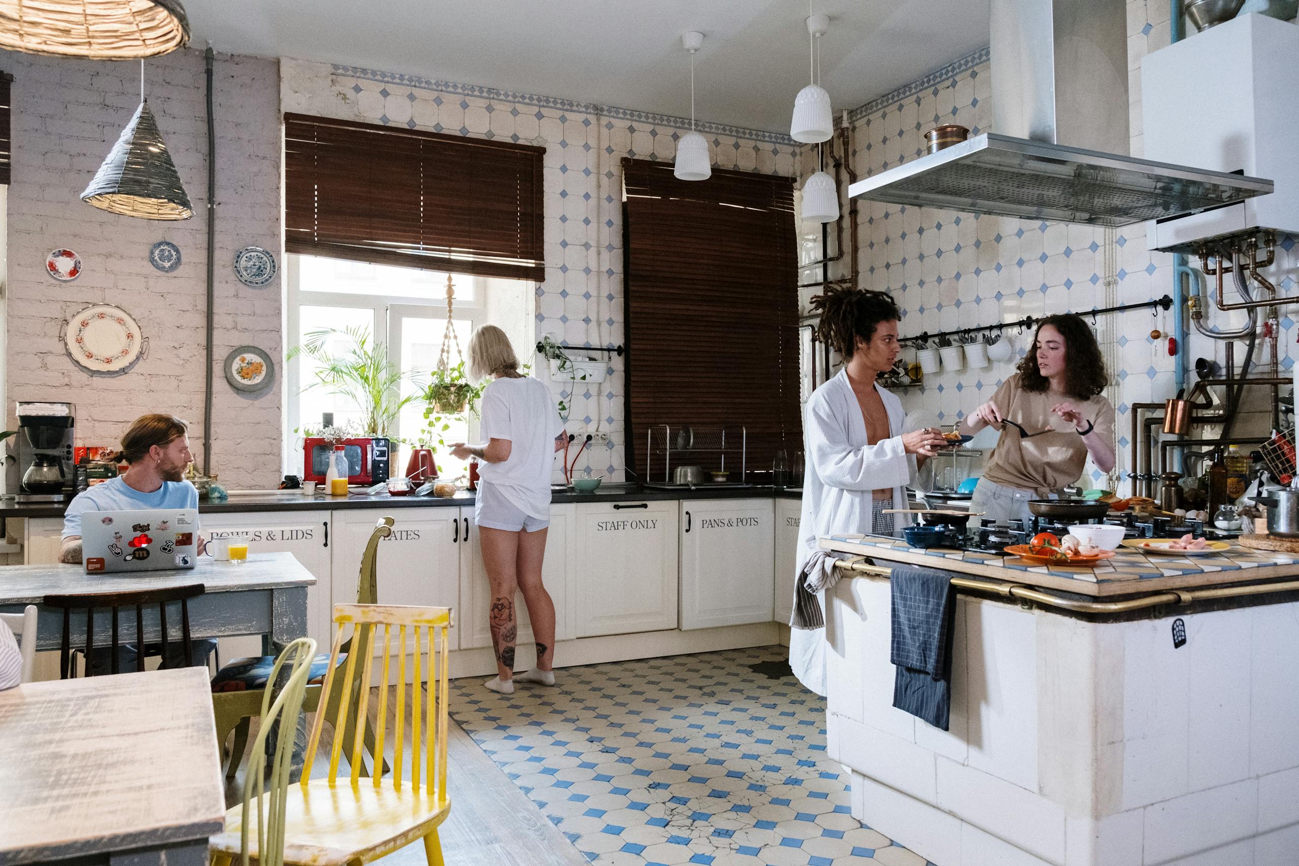 Friends enjoying a cozy day cooking together in a stylish kitchen setting.